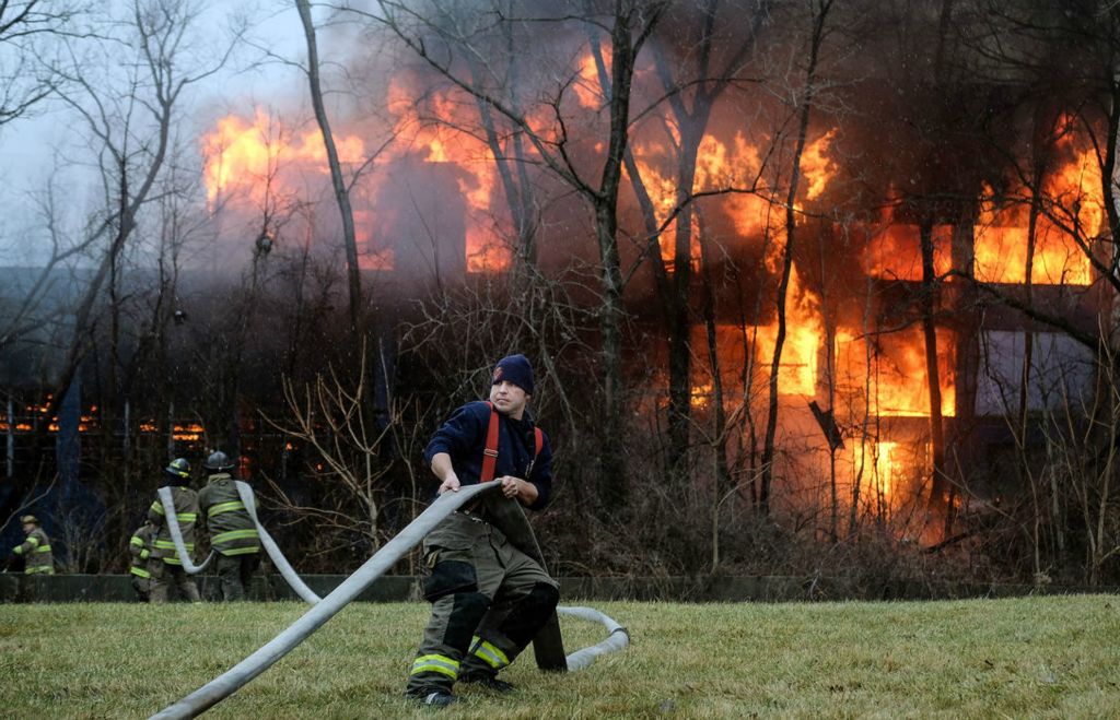 Spot News - 3rd place - Firefighters work to put out a blaze at a building that once belonged to the Toledo Pressed Steel Corp. on Phillips Avenue in Toledo. 
 (Jeremy Wadsworth/The Blade)