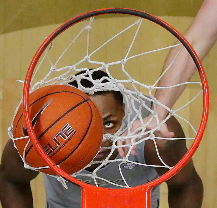 Sports - 1st place - University of Akron forward Camron Reece eyes down a shot made by Akron guard Tyler Cheese during the first half of a game against the Buffalo Bulls at James A. Rhodes Arena in Akron.  (Jeff Lange/Akron Beacon Journal)