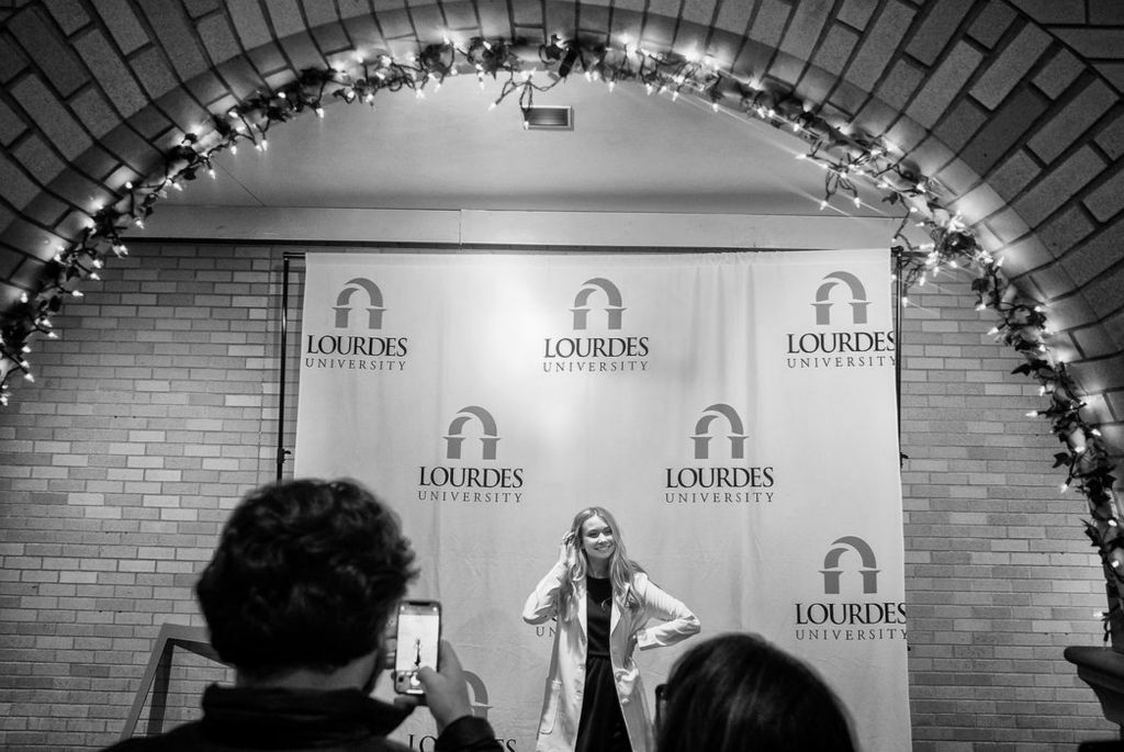 Story - 3rd place - Erynn Groll of Oregon poses for pictures after the Lourdes University College of Nursing White Coat Ceremony for new Nursing Students at Lourdes University in Sylvania.  (Jeremy Wadsworth/The Blade)