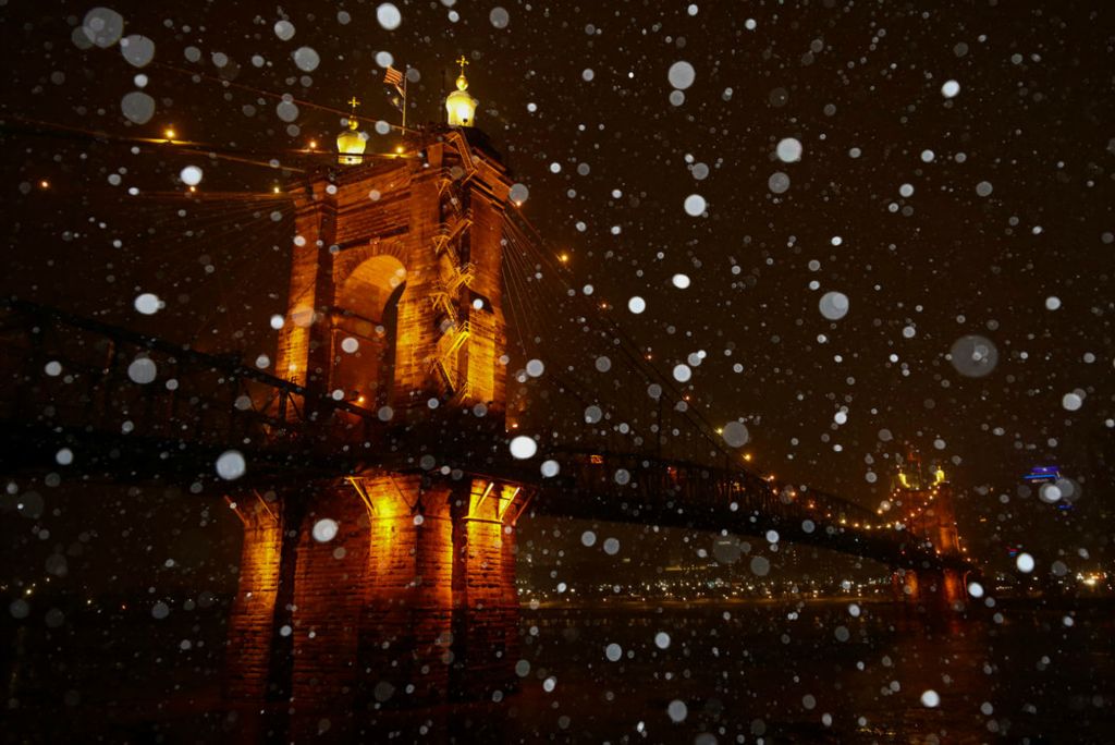 Feature - 1st place - Snow falls at the John A. Roebling Suspension Bridge overlooking the Ohio River into Cincinnati from Covington, Ky. About two inches of snow accumulated across the Cincinnati area. (Kareem Elgazzar / The Cincinnati Enquirer)