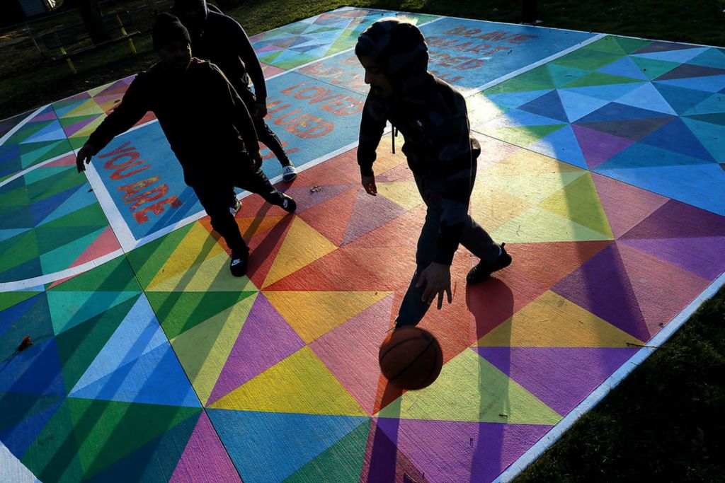 Feature - 3rd place - A group of friends play basketball at a park along Woodward Avenue as the sunsets. The basketball court was painted by at risk students in Project Jericho last year.  (Bill Lackey / Springfield News-Sun)