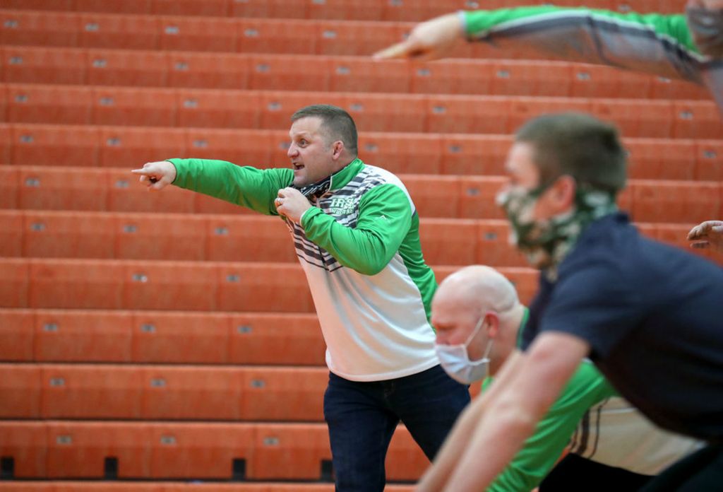 Sports Feature - 3rd place - Dublin Scioto wrestling head coach Adam Huddle calls out to Tarone Jackson as he competes against Delaware Hayes' Chase Radabaugh in their 113-pound match at Delaware Hayes High School. (Shane Flanigan / ThisWeek Community News)