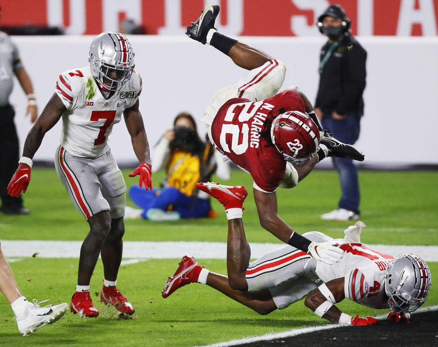 Sports - 3rd place - Alabama running back Najee Harris (22) dives into the end zone over Ohio State safety Josh Proctor (41) on his way to scoring a 26-yard touchdown during the second quarter of the College Football Playoff National Championship game at Hard Rock Stadium in Miami Gardens, Fla.  (Kyle Robertson / The Columbus Dispatch)