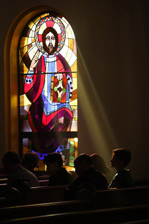 Feature - 1st place - Jackie Ansara sits in a beam of sunlight during the Hierarchical Divine Liturgy at St. George Antiochian Orthodox Cathedral in Toledo.  (Rebecca Benson / The Blade)