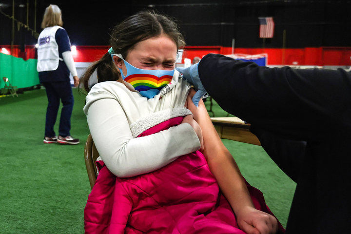 General News - 1st place - Abby Minardi, 7, winces as she gets her vaccine at the Lucas County Recreation Center in Maumee.  (Rebecca Benson / The Blade)