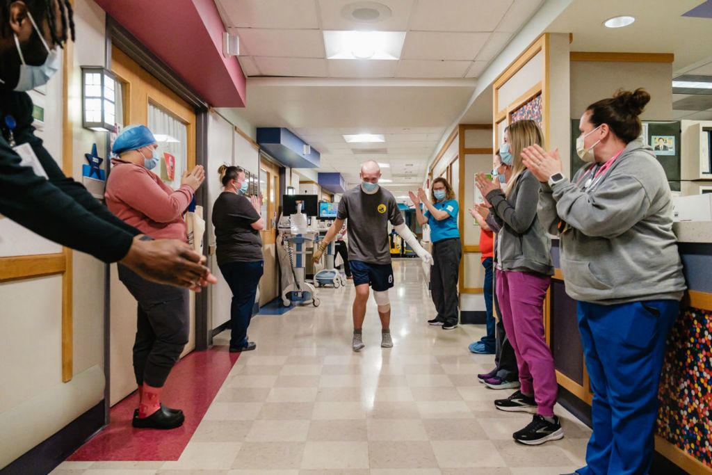 Feature - 2nd place - Cameron Costello dances to his favorite music as hospital staff perform a clap-out in the Regional Burn Center at Akron Children’s Hospital. Costello was burned in a house fire in Canton. He is a Tuscarawas Central Catholic High School graduate. (Andrew Dolph / The Times Reporter)