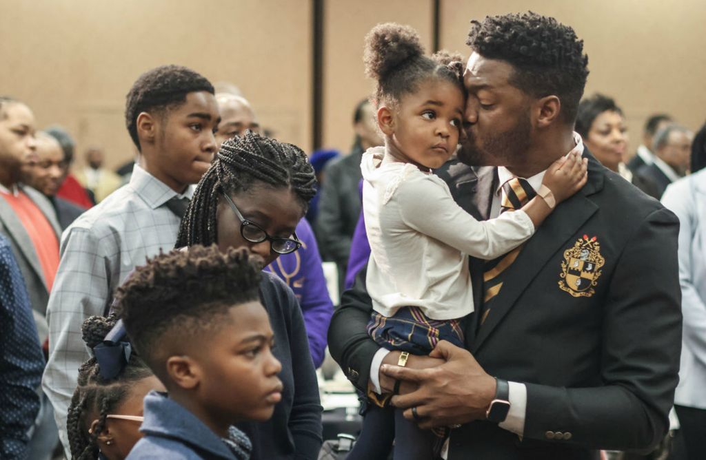 General News - 2nd place - Corey Parker of Toledo kisses his daughter Ashlynn, 3, as “Lift Every Voice and Sing” is played by Mike Willams during the 31st annual Dr. Martin Luther King, Jr. Scholarship Breakfast at The Pinnacle in Maumee.  (Jeremy Wadsworth / The Blade)