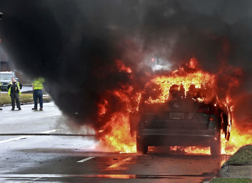 Spot News - 3rd place - South Limestone Street was blocked while the Springfield Fire Division extinguished a fully involved car fire in one of the southbound lanes. The driver escaped without injury. He said the van just lost power so he stopped and it caught fire.  (Bill Lackey / Springfield News-Sun)