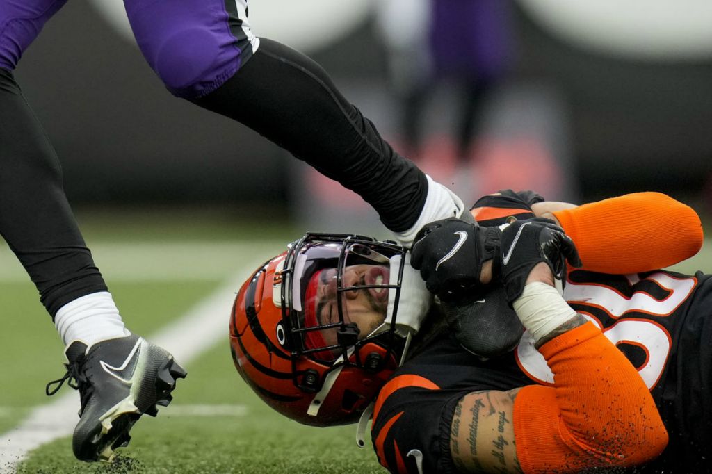 Sports - 1st place - Cincinnati Bengals safety Jessie Bates III (30) hangs onto the foot of Baltimore Ravens tight end Isaiah Likely (80) after a catch in the fourth quarter at Paycor Stadium in Cincinnati. (Sam Greene / The Cincinnati Enquirer)