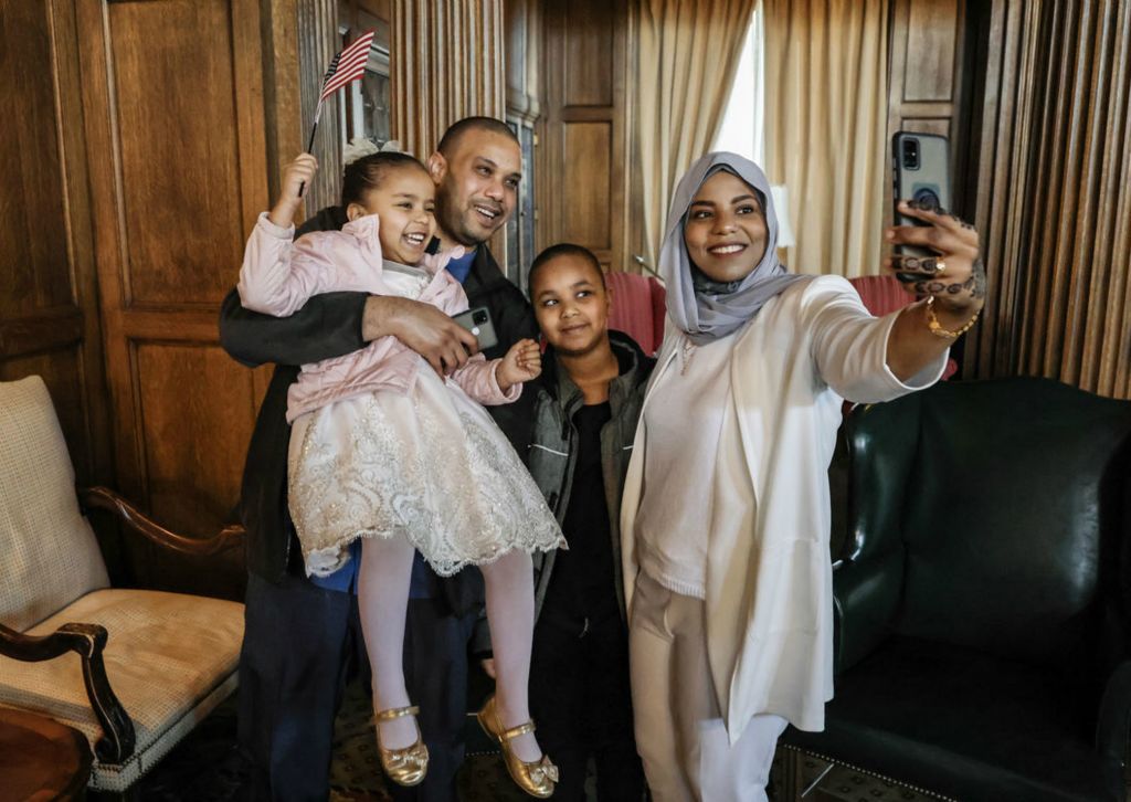 Story - 3rd place - Mohamed Hashim, originally from Sudan, celebrates becoming a U.S. Citizen by taking a selfie with his wife Ihsan, daughter Jenan, 4, and son Ayman, 8, after a Naturalization Ceremony at the Toledo Club in Toledo.   (Jeremy Wadsworth / The Blade)