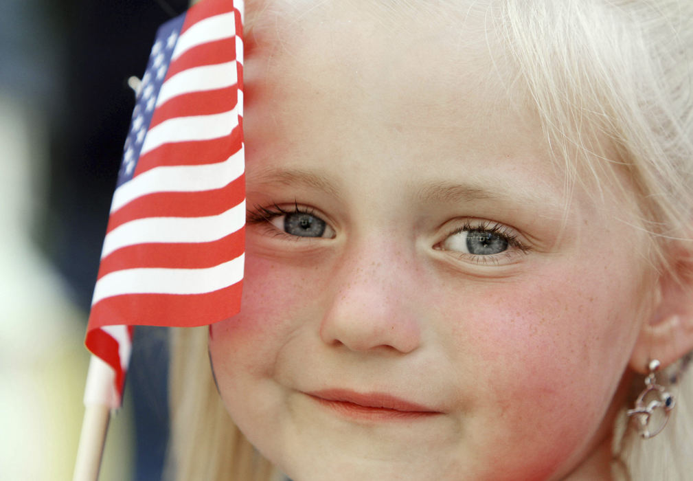 Portrait - 3rd place - Allison Shaeffer, of Zanesville, occupies herself with a American Flag that was given to her by the United State Army during the Red, White and Boom Parade in downtown Columbus. (Neal C. Lauron / The Columbus Dispatch)