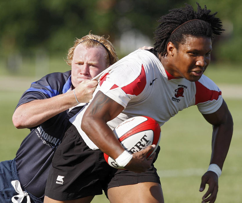 Sports - 2nd place - Hilliard Bearcat's Alex DeWitt (left) tackles Westerville Worm's Kalen King during the Columbus High School Olympic Rugby at Beekman Park at Ohio State University.  (Kyle Robertson / The Columbus Dispatch)