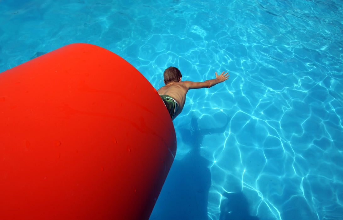 Feature - 1st placeMichael Scott, of Columbus goes headfirst into a hot day at the Hilltop Swim Club in Columbus . (Eric Albrecht / The Columbus Dispatch)