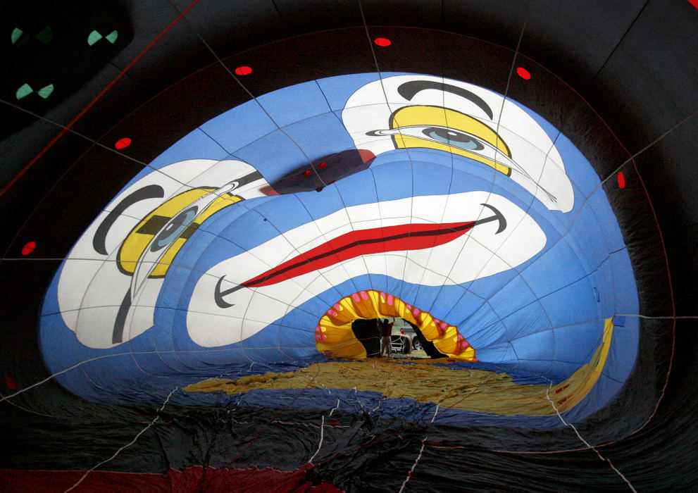 Feature - 2nd placeMatt McClinton, of Clown-N-Around, holds a balloon open as it is inflated during the Pro Football Hall of Fame Festival Balloon Classic Invitational. (Scott Heckel / The Repository)