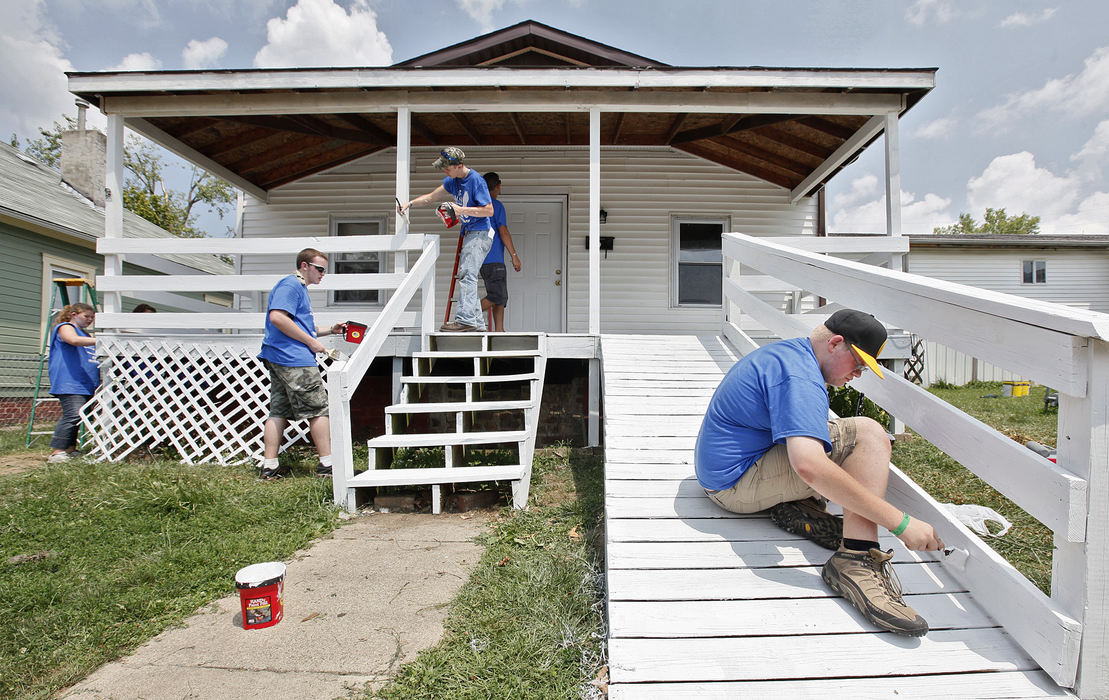 General News - 3rd placeChristopher Woodard, a SkillsUSA volunteer from Ohio HiPoint Career Center in Bellefontaine, works with his peers to paint a handicap ramp on a house in Glouster. (Chris Russell / The Columbus Dispatch)