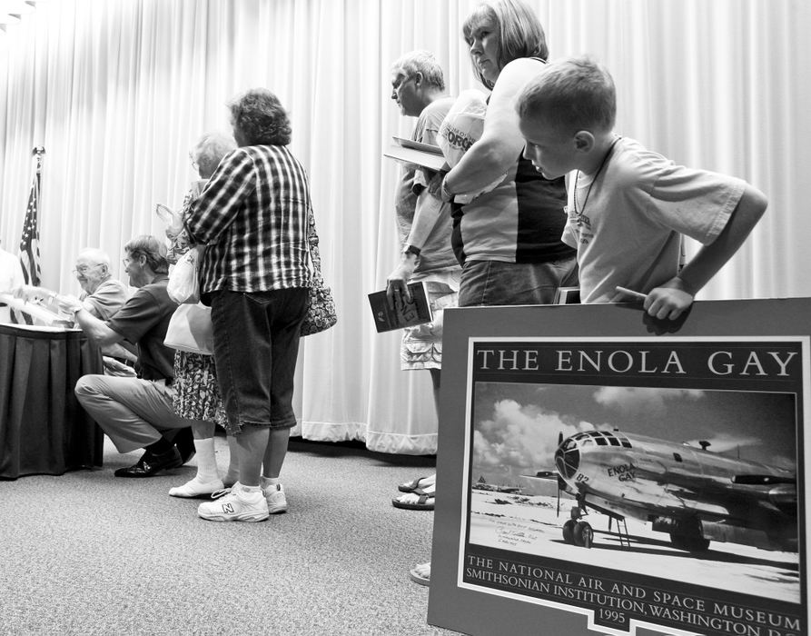 General News - HMCaleb Antram, 8, eagerly waits to have a poster signed by USAF (Ret.) Capt. Dutch Van Kirk, the navigator on the B-29 Enola Gay, who discussed his experiences in World War II including the mission which dropped the atomic bomb on Japan during a speaking appearance. (Barbara J. Perenic / Springfield News-Sun)