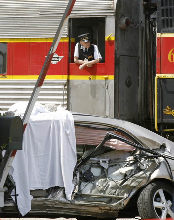 Spot News - 1st placeA Cuyahoga Valley Scenic Railroad train collided with a mid-sized car on Portage Street NW just west of Whipple Avenue NW in Jackson Township. The driver was killed. Here a trainman looks out the door from the train. (Scott Heckel / The Repository)