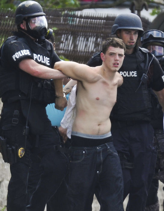 Spot News - 3rd placeMembers of the Springfield Police Division's Special Operations Team arrest murder suspect Laune Dozier after a standoff at 730 East Street where he refused to surrender. (Bill Lackey / Springfield News-Sun)