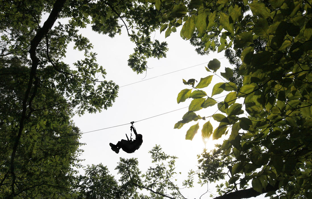 Story - 3rd placeA client goes zipping through the trees at Camp Mary Orton as ZipZone guides wrap up their training by giving friends and family a chance to experience the zip line course.  (Chris Russell / The Columbus Dispatch)