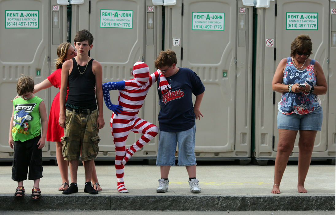 Feature - 3rd place(From left) Dylan Warner, Kathy Gillespie, Franklin Smith, Jonathan Warner, and Ethan Warner, all of Obetz, stand and await the beginning of the parade while fellow onlooker Sue Pettiford checks her phone before the start of the the Independence Day Parade, part of the Red, White and Boom festivities on Front Street in downtown Columbus. (Brooke LaValley / The Columbus Dispatch)