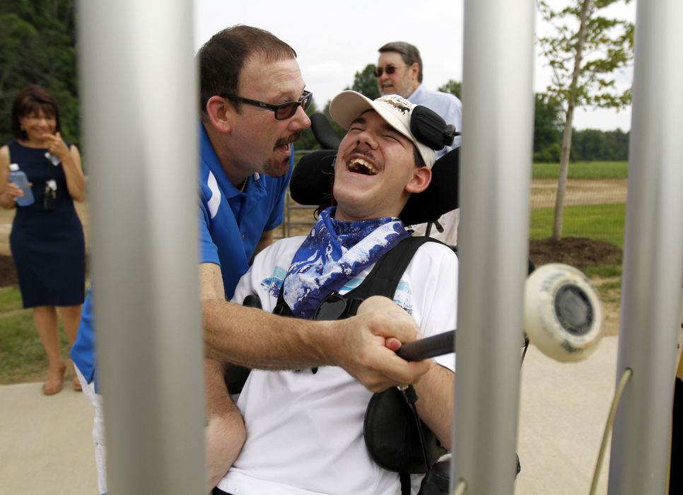 General News - 2nd placeGreg Vanche and his son Nicholas Vanche play a tune on the new chimes installation at the newly-opened Inclusive Playground at Hollstein Reservation in Amhers. The inclusive playground offers activities and places to play for children of all ages and physical abilities. a fishing pond, wheelchair accessible swings and musical installations are all part of the new playground.  (Sam Greene / The (Lorain) Morning Journal)