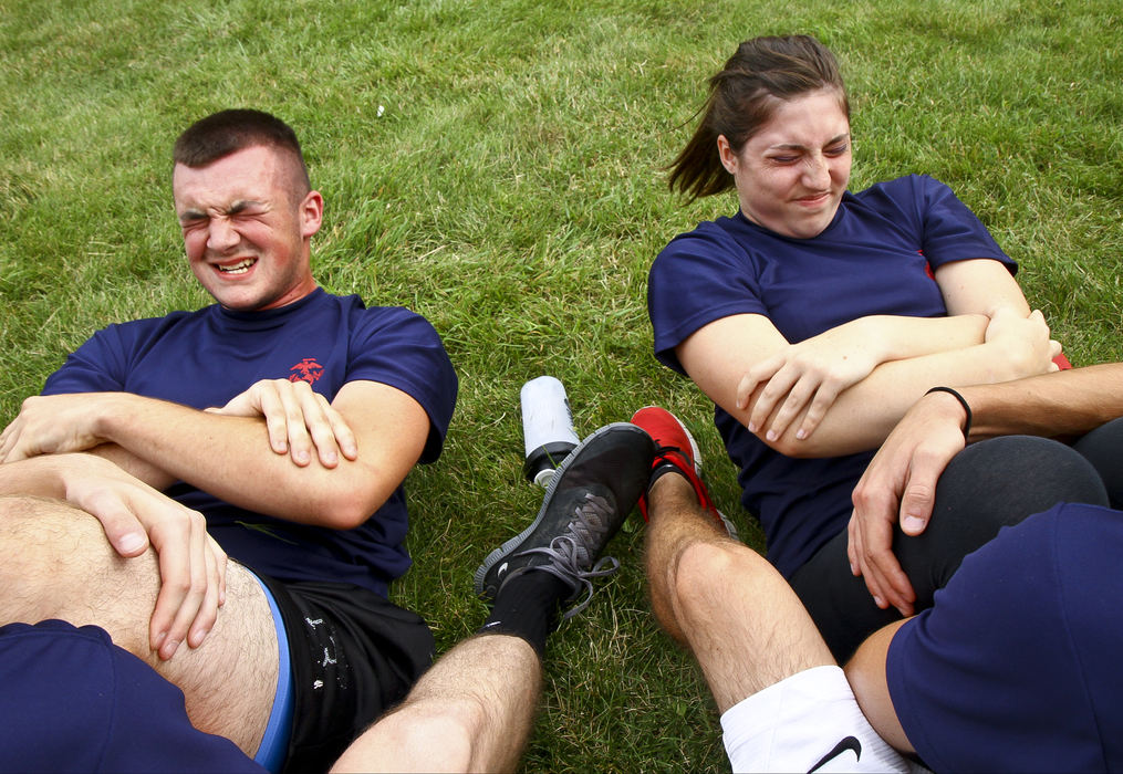 General News - 3rd placeMarine recruits Cameron Diviak, and Vanessa Summers, attempt to do as many sit-ups as possible in two minutes while working out at the Armed Forces recruiting center. Summers is only one of a handful of female recruits in the region and must meet different physical requirements than her male counterparts. (Barbara J. Perenic / Springfield News-Sun)