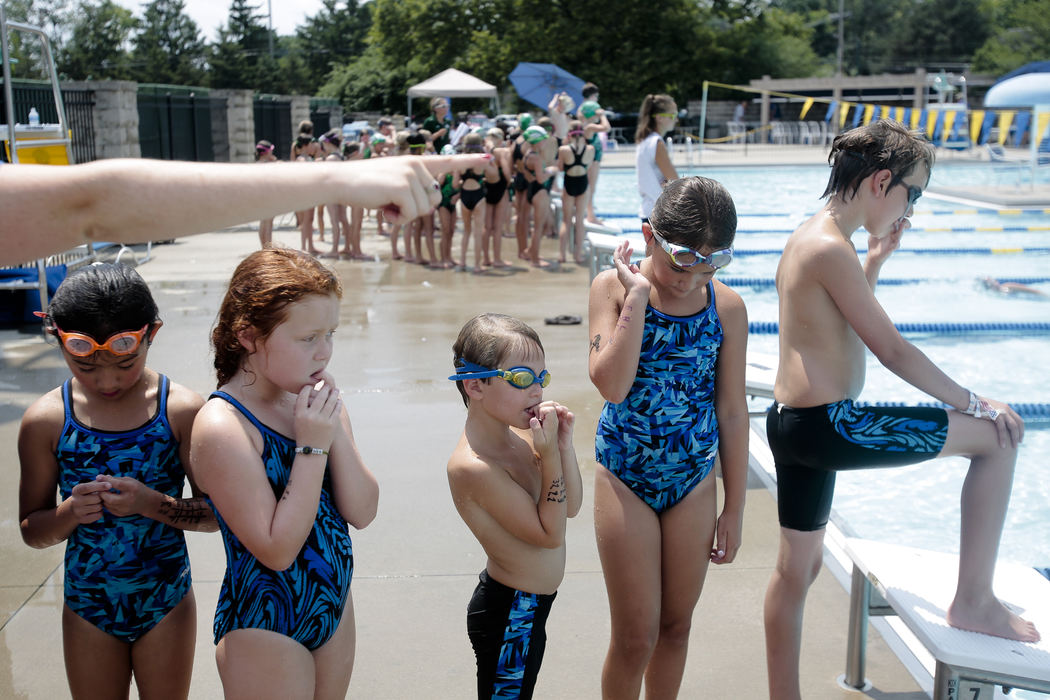 Sports Feature - 1st placeUpper Arlington Sea Dogs swimmer Logan Layish, (center) waits with his teammates, (from left) Danielle Grim, Caroline Kegg, Ellie Layish, and Rory Brennan as they warm-up before the start of the 10-and-under session at the SSCL Swimming Championships at the Swim and Racquet Club in Upper Arlington. (Joshua A. Bickel / ThisWeek Community News)