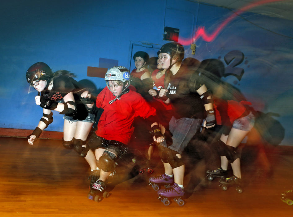 Sports - HM(From left) Avarie "Redrider" Sparrow, Ayla "Blur" Hottensmith, and Sara "Crickett" Herman mix it up during practice at the Sunbury Skate Club. The girls are part of a new junior program for roller girls. (Eric Albrecht / The Columbus Dispatch)