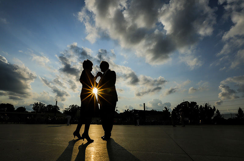 Feature - 1st place - Sandy Feicht and Duane Mills, both of Sandusky, enjoy a dance against the setting sun as Centennial Terrace celebrates its 75th anniversary with the Johnny Knorr Orchestra.   (Andy Morrison / The (Toledo) Blade)