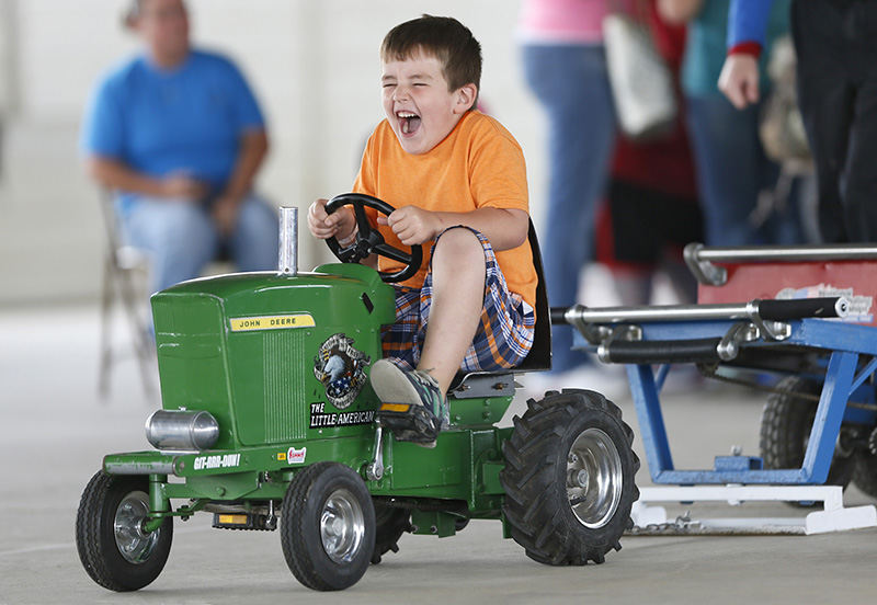 Feature - HM - Five year-old Aiden Sabo was happy to be competing in the National Kiddie Tractor Pullers Association competition at the Ohio State Fair. (Chris Russell / The Columbus Dispatch)