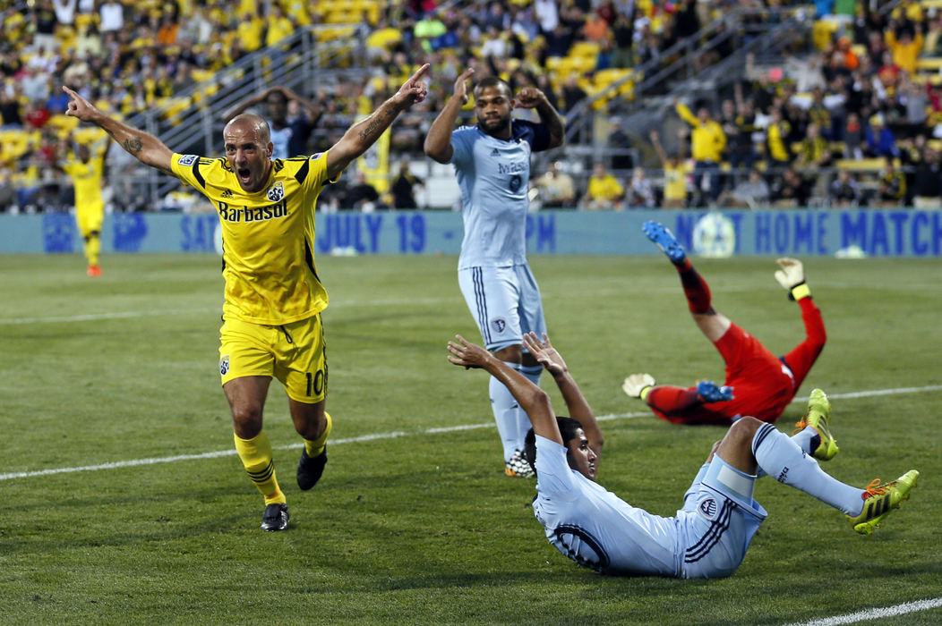 Sports Feature - 1st place - Columbus Crew forward Federico Higuain (10) celebrates an own goal by Sporting KC defender Igor Juliao (40) on a ball that got past Sporting KC defender Kevin Ellis (4) and goalkeeper Andy Gruenebaum (30) during the second half of their game at Crew Stadium in Columbus. The goal tied the game, but the Crew lost 2-1. (Adam Cairns / The Columbus Dispatch) (Adam Cairns / The Columbus Dispatch)