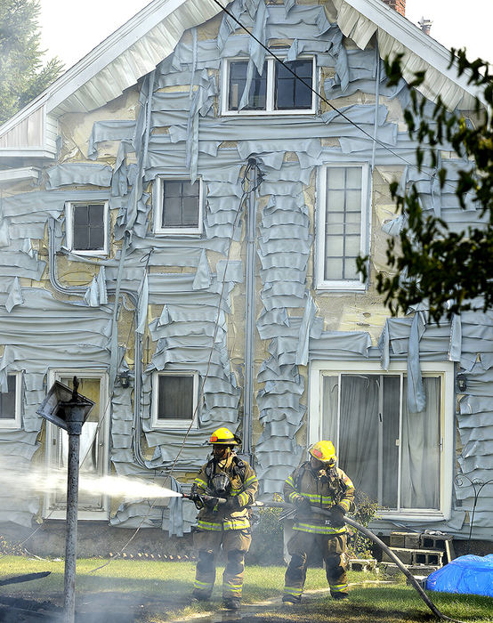 Spot News - 2nd place - Members of the Springfield Fire Division extinguish a blaze that destroyed a detached garage and damaged several houses on Woodside Avenue. Firefighters had two garage fires burning in the same neighborhood at the same time and another garage fire in that neighborhood the previous day. (Bill Lackey / Springfield News-Sun)