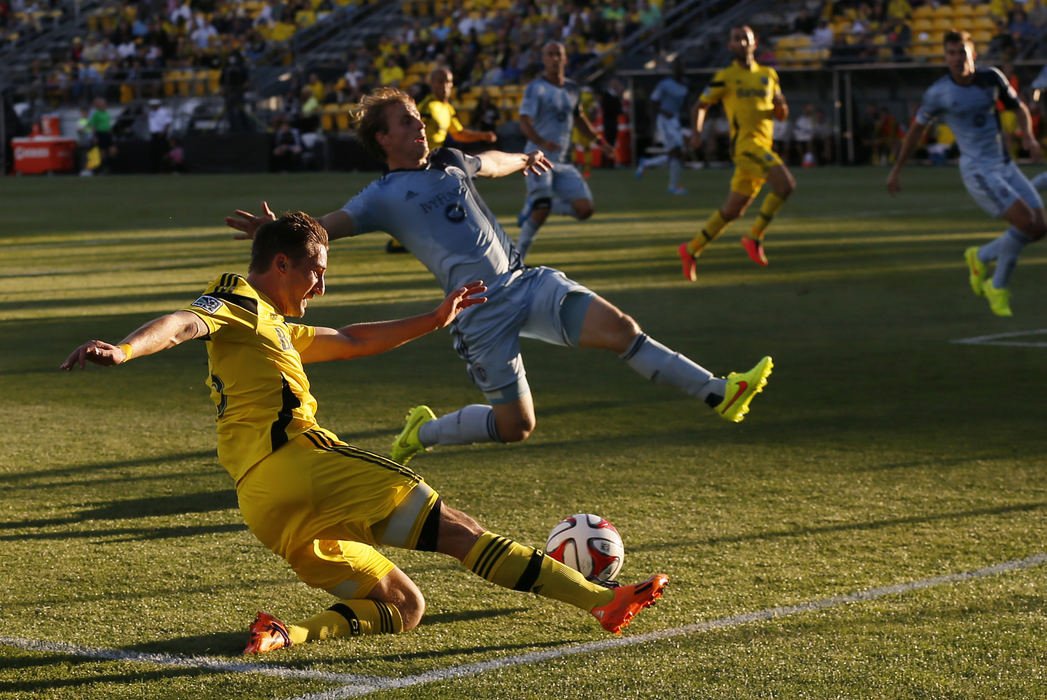 Sports - 1st place - Columbus Crew midfielder Ethan Finlay (13) tries to center the ball past Sporting KC defender Seth Sinovic (15) during the first half of their game at Crew Stadium in Columbus. (Adam Cairns / The Columbus Dispatch)