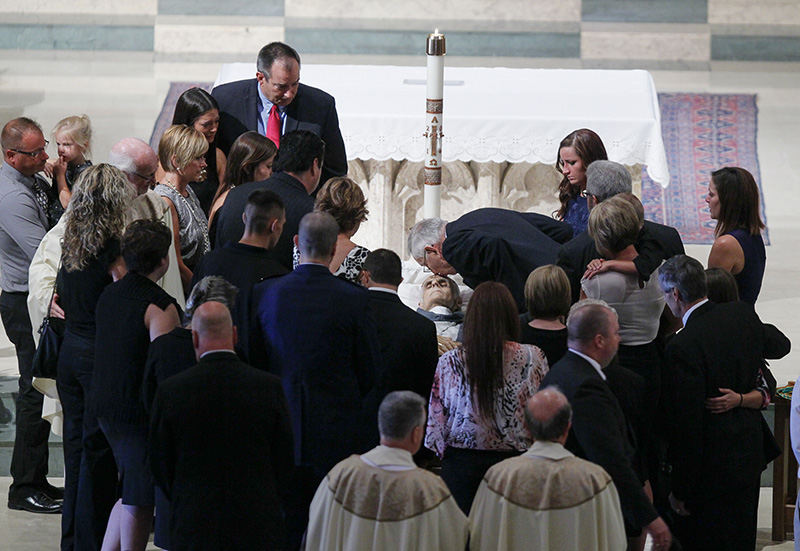 Story - 2nd place - Family members say goodbye to Auxiliary Bishop Robert Donnelly during funeral services for him at Our Lady, Queen of the Most Holy Rosary Cathedral. (Andy Morrison / The (Toledo) Blade)