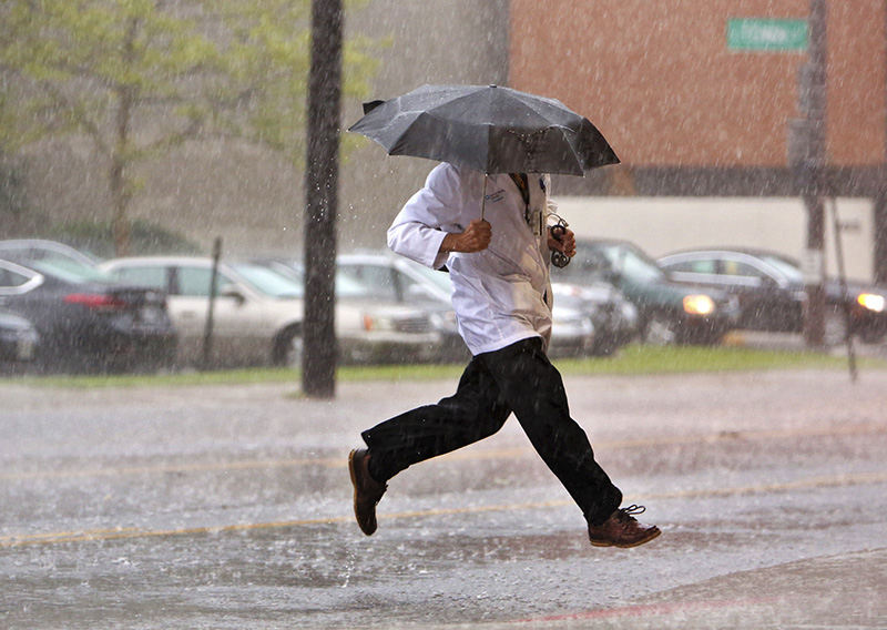 Feature - 3rd place - Dr. Bob Skully of Columbus makes a dash across Grant St. during a afternoon thunderstorm in Columbus as he shows up for work at Grant Medical Center (Eric Albrecht / The Columbus Dispatch)