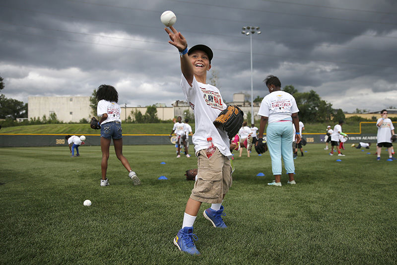 ASports Feature - 2nd place - Preston Jacobs, 12, of Lawrenceburg, Ind., participates in helped break the world record for the largest game of catch at the P&G Urban Youth Academy in Bond Hill.  (Kareem Elgazzar / The Cincinnati Enquirer)