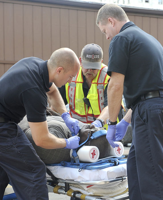 Spot News - 3rd place - An unidentified victim is strapped to a stretcher following a car accident near the corner of Main St. and Third St. Three people total were transferred to hospital.  (Lisa Bernheim / The (Mansfield) News Journal)