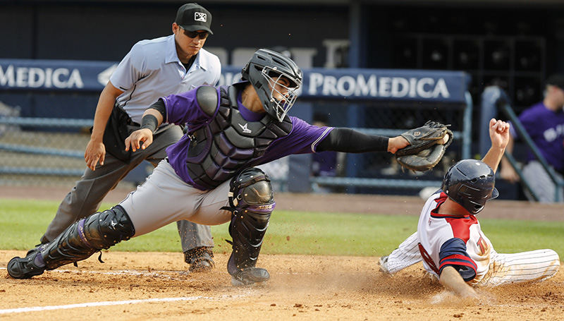 Sports - 1st place - Toledo Mud Hens' Josh Wilson (8) scores as Louisville Bats catcher Ramon Cabrera (38) can't make the tag during the fifth inning of the first game of their double header at Fifth Third Field. (Andy Morrison / The (Toledo) Blade)