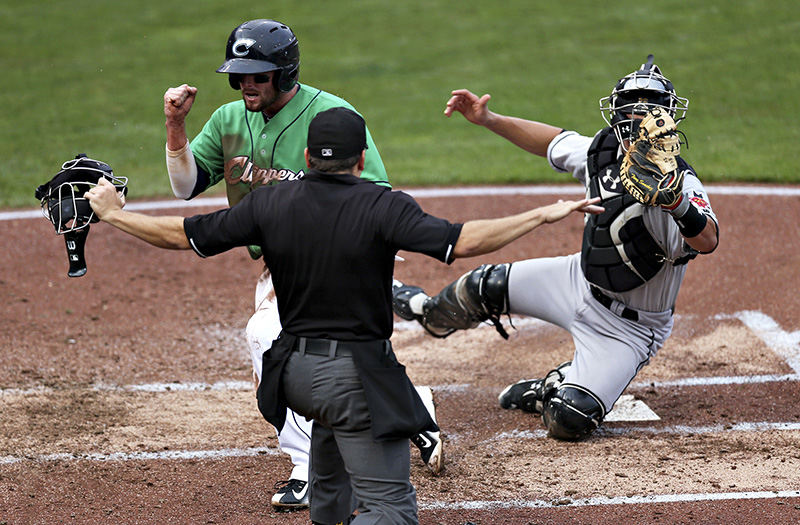 Sports - HM - Columbus Clippers right fielder Tyler Holt cheers as he makes it safely across home plate and scores the first run against the Indianapolis Indians at Huntington Park on July 10.  (Leah Klafczynski / The Columbus Dispatch)