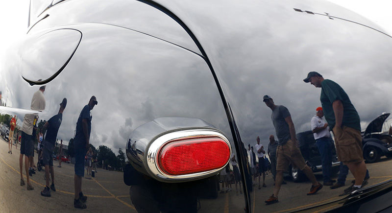 Story - 3rd place - Visitors are reflected in the rear of a 1948 Ford Coupe owned by Dick Schaeffer of Maryland at the 18th Goodguys PPG Nationals event at the Ohio Expo Center. (Jonathan Quilter / The Columbus Dispatch)