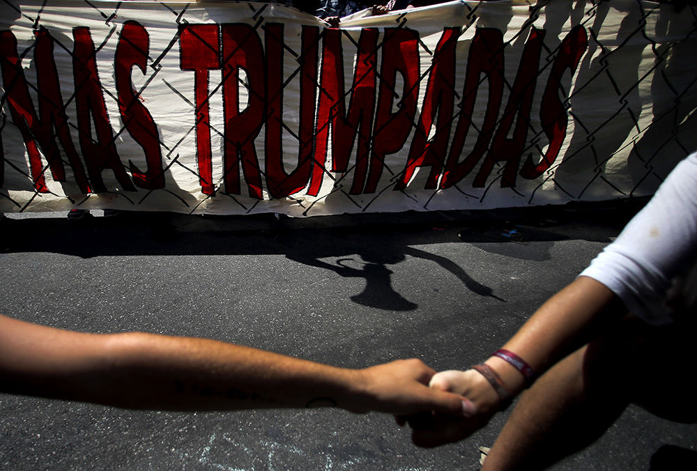 General News - 3rd place - Wall Off Trump protesters form a human wall along Prospect Ave. on day three of the Republican National Convention in Cleveland. (Kyle Robertson / The Columbus Dispatch)