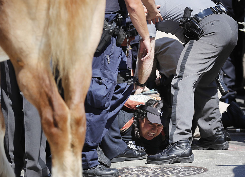 ASpot News - 2nd place - A woman is detained by police at the scene of a civil disturbance during the third day of the Republican National Convention in Cleveland. There was a report of a potential flag burning in the area at the time.  (Adam Cairns / The Columbus Dispatch)