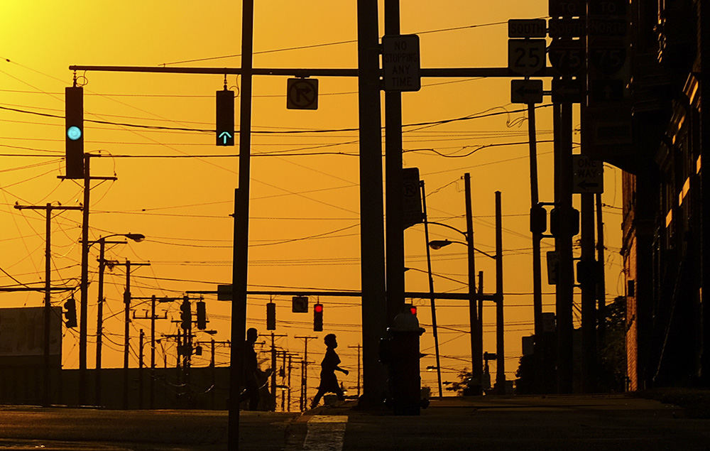    Feature - 1st place - Pedestrians cross Washington Street as the sun sets in Toledo. (Jeremy Wadsworth / The Blade)