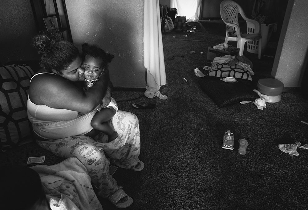    General News - 1st place - Kayla Ballez hugs her son Damarco, 1, at her home on Elm Street in Toledo. The family's home was ransacked and they were held hostage during a home invasion the previous night. (Jeremy Wadsworth / The Blade)