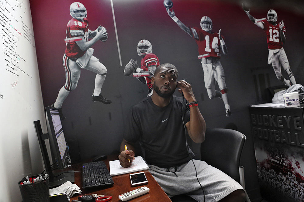 sp Sports Feature - HM - As summer draws to a close and kickoff nears Ohio State quarterback J.T. Barnett studies film and takes notes at the Woody Hayes Athletic Center in preparation of the season. (Eric Albrecht / The Columbus Dispatch)