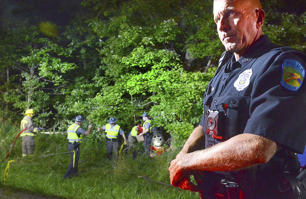 Spot News - 1st place - St. Clair Township police officer Jaspar Cannon stands near the scene of a fatal accident on Old Fredericktown Road. (Patricia Schaeffer / The (Lisbon) Morning Journal)