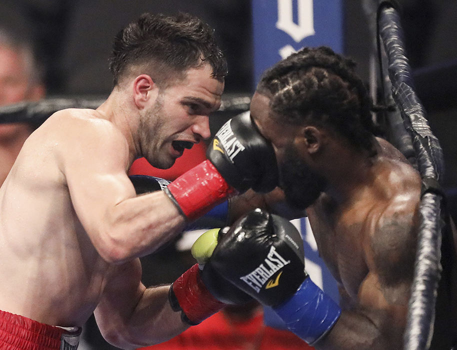    Sports - 1st place - Enver Hallili of Brooklyn, New York (left) defeats Wesley Tucker of Toledo by decision in a Welterweight match at the Huntington Center in Toledo. (Jeremy Wadsworth / The Blade)