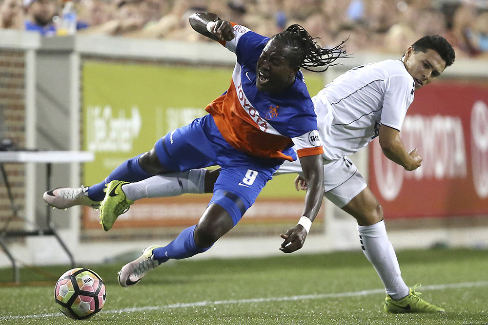 SSports - 2nd place - FC Cincinnati forward Djiby Fall (9) is tackled from behind in the second half during a USL match against Harrisburg City Islanders at Nippert Stadium in Cincinnati.  (Kareem Elgazzar / Cincinnati Enquirer)