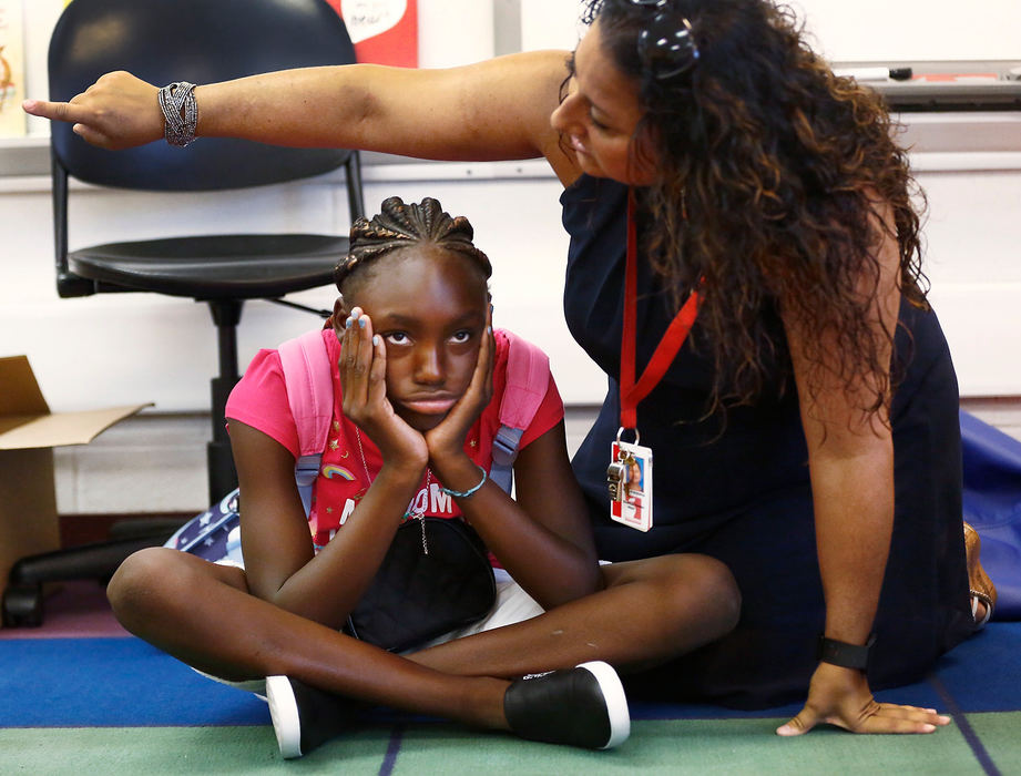 Feature - 1st placeWoodcrest Elementary is the only Columbus City School building that has a "year round" academic calendar, taking just a month off in the summer and a few extended breaks throughout the year. Fourth grader Nycheffe Phillips sits with her head in her hands after her teacher, Sonja DeGenova, told her not to speak without raising her hand first.  (Fred Squillante/The Columbus Dispatch)