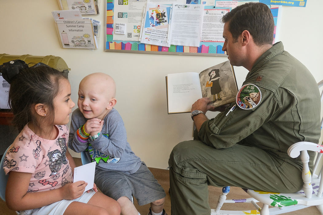 General News - 2nd placeMajor Phillippe Brule of the 180th Fighter Wing reads a story to Arabella Flores, 5, (left) of Toledo and Braylon Gose, 4, (center) of Bowling Green at ProMedica Toledo Children's Hospital. Gose is being treated for cancer.  (Jeremy Wadsworth/The Blade)